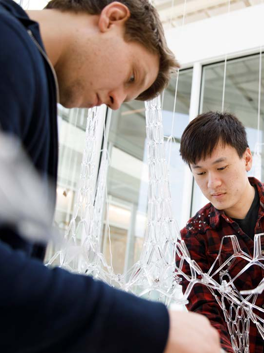 Two students work on the Amatrea sculpture.